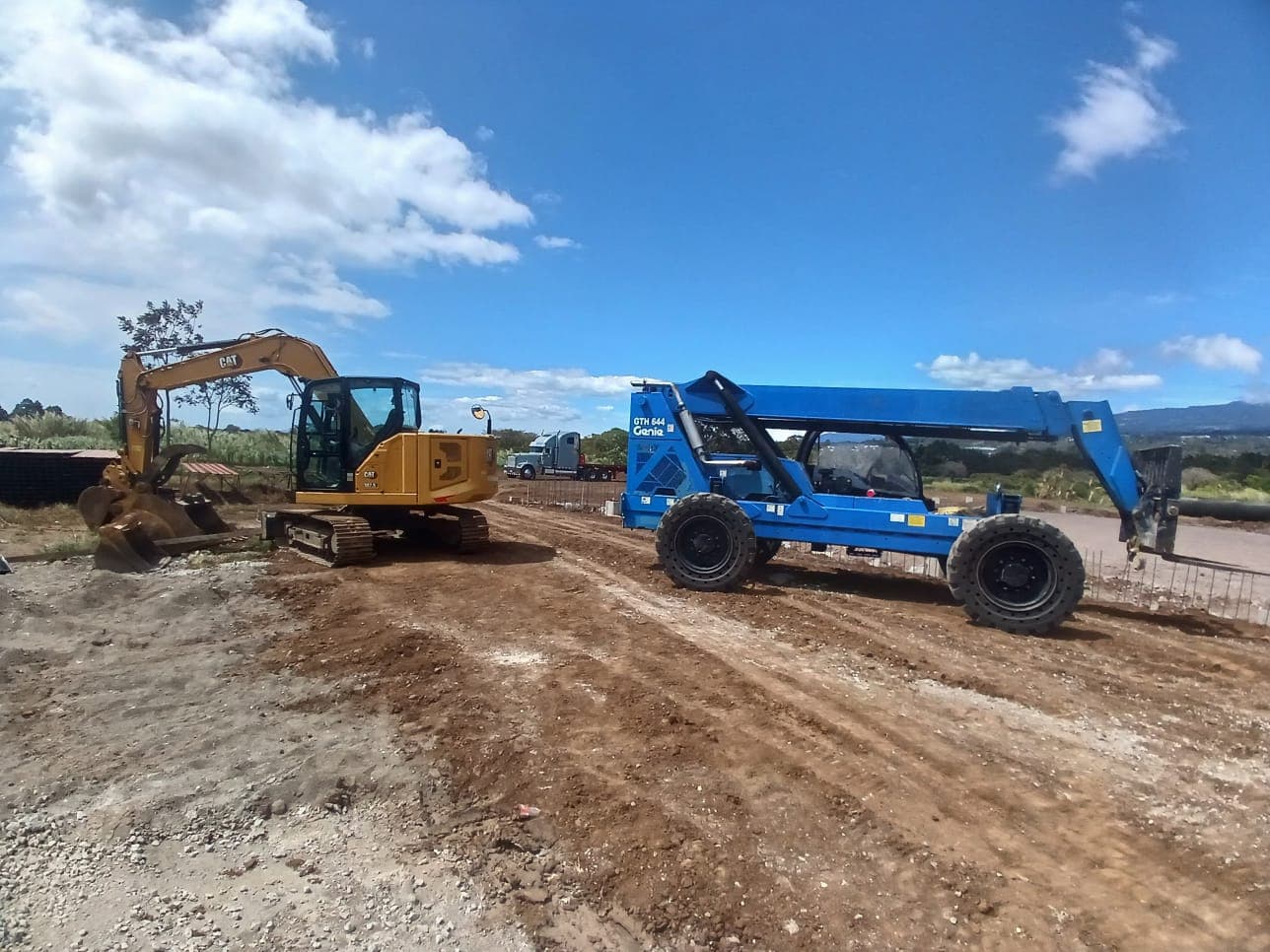 Telehandler Genie y excavadora CAT en un movimiento de tierra